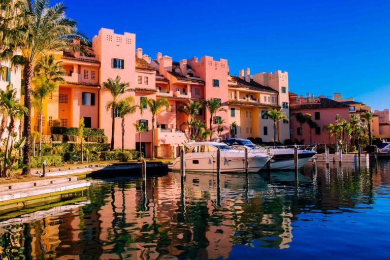 uxurious waterfront properties in Sotogrande with moored yachts under the clear blue skies, reflecting the exclusive lifestyle of one of Spain's most sought-after residential areas.