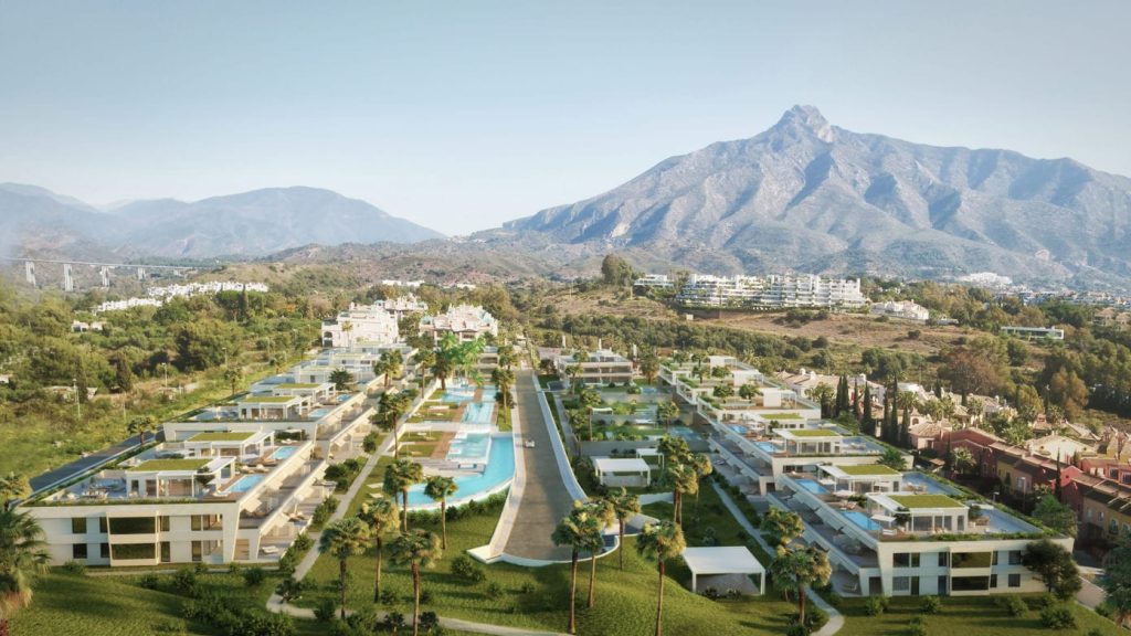 Modern luxury villas in Marbella with lush landscaping and La Concha mountain in the distance.
