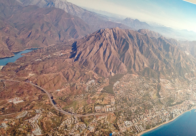 Aerial view of Sierra Blanca's lush landscape with La Concha mountain overlooking Marbella and the Mediterranean coastline.