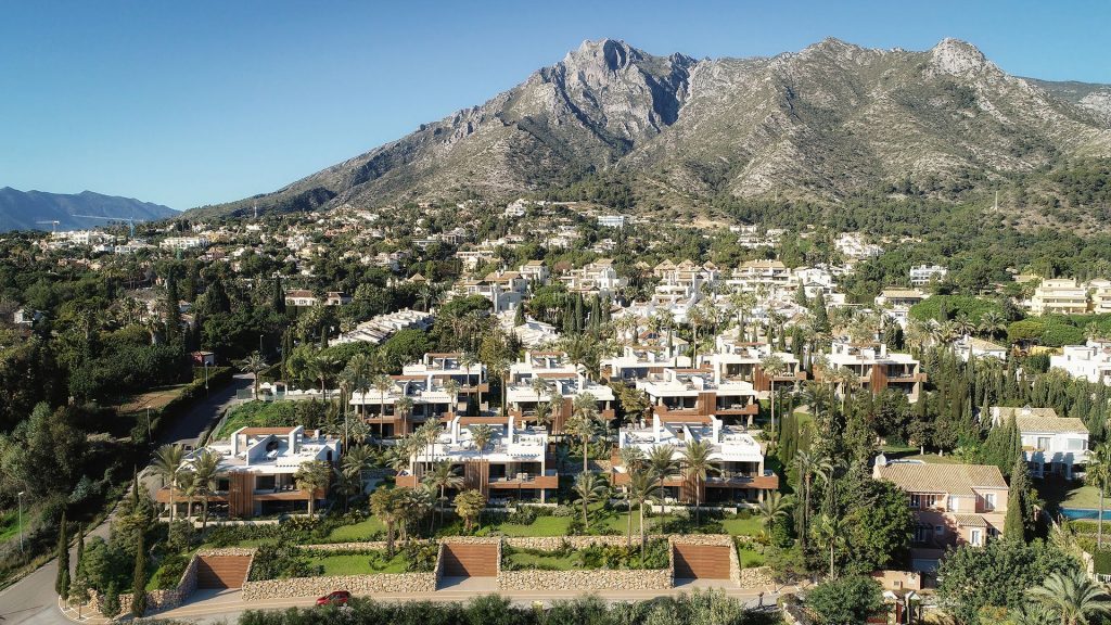 Sierra Blanca luxury residential community in Marbella with the scenic La Concha mountain in the backdrop under clear blue skies.